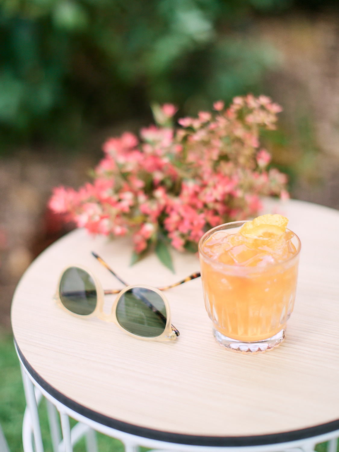 Cocktail and sunglasses on side table