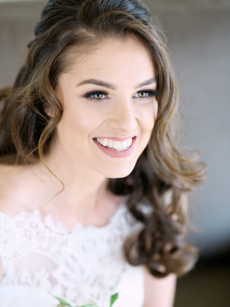 Closeup of bride with with her hair and makeup done smiling