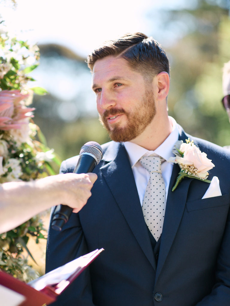 Groom saying his vows into microphone